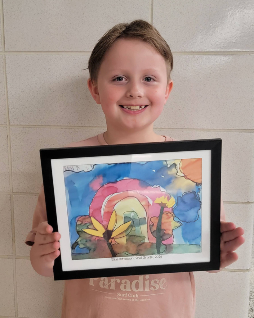 2nd grader Elias K. holding their watercolor illustration of a rainbow and flowers.