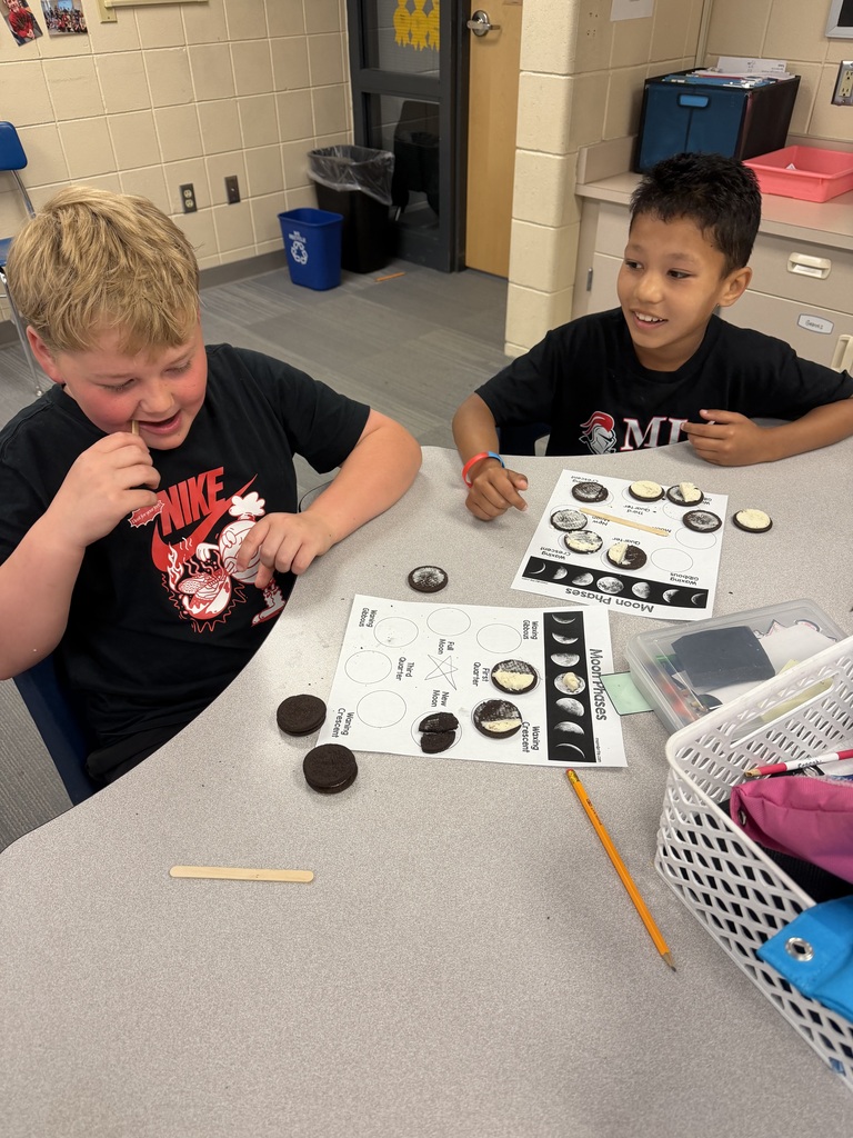 2 students working on their moon phases.
