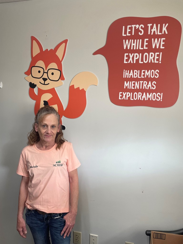 Michelle standing in front of a wall