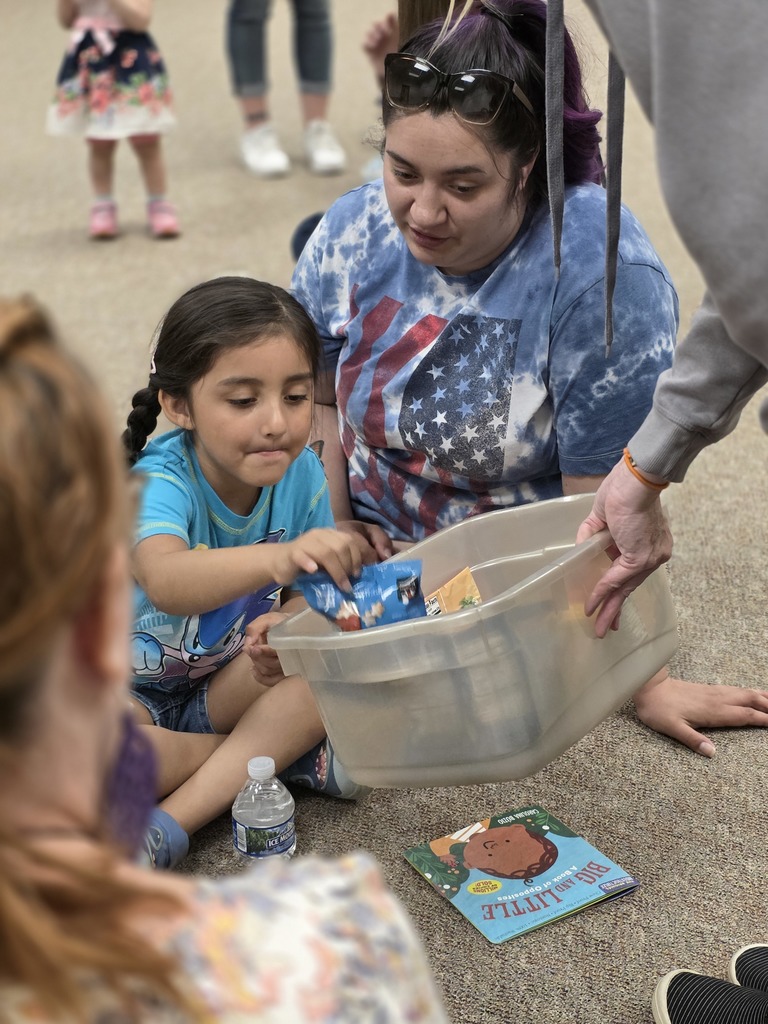 group of children sitting on the ground and playing