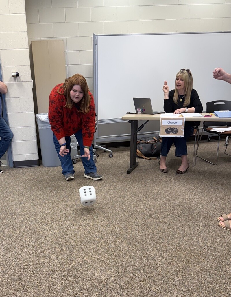 Reality Fair student rolling a giant dice