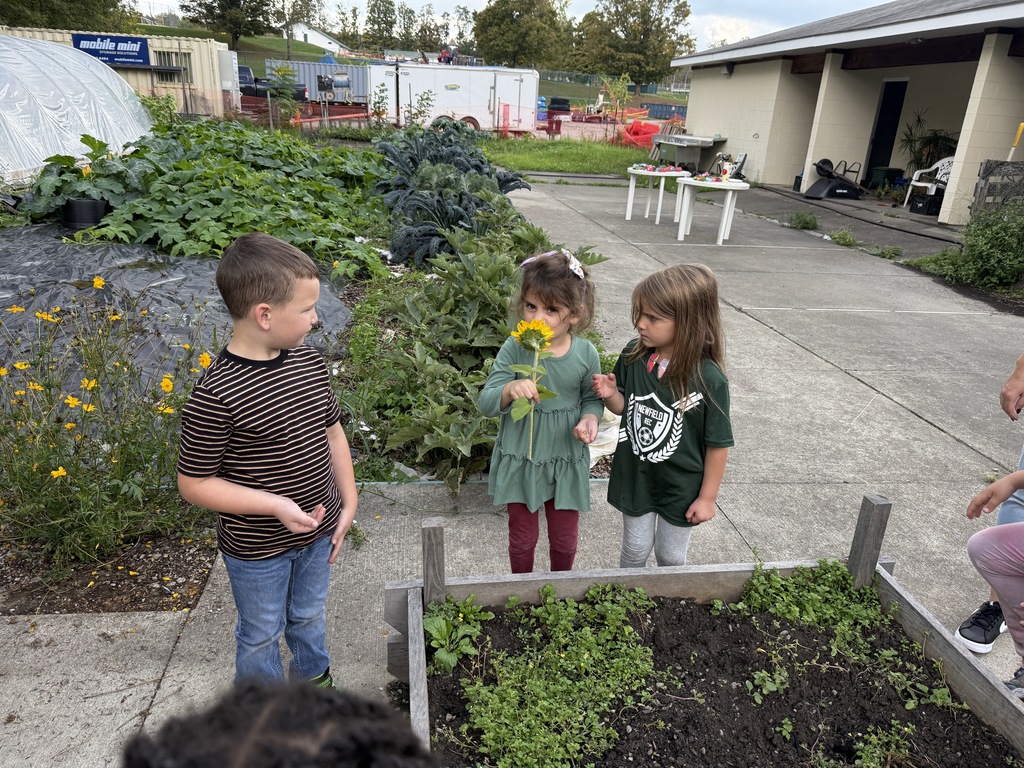 students smelling flowers