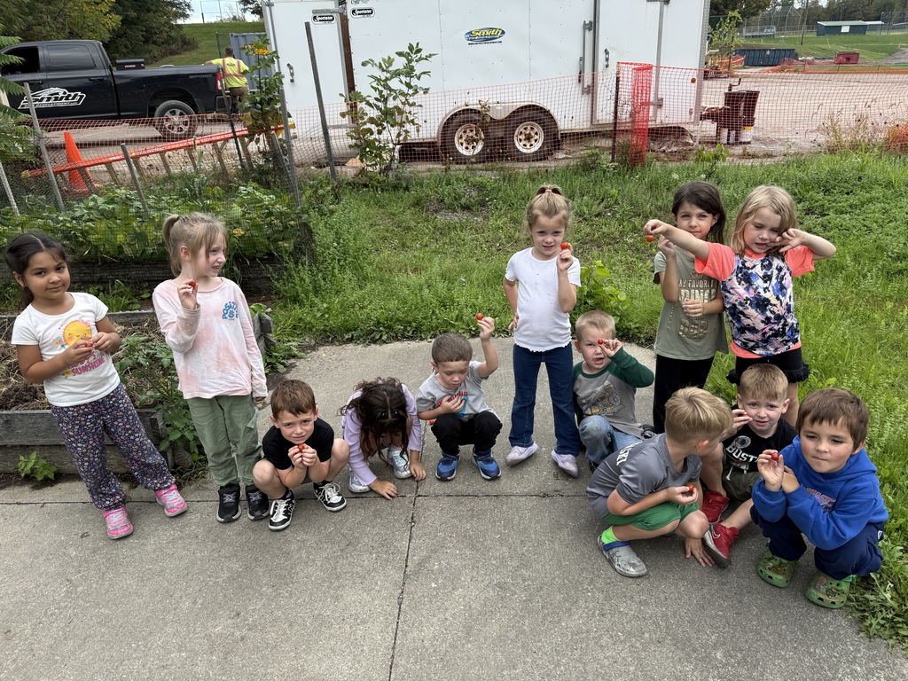 students smiling with cherry tomatoes