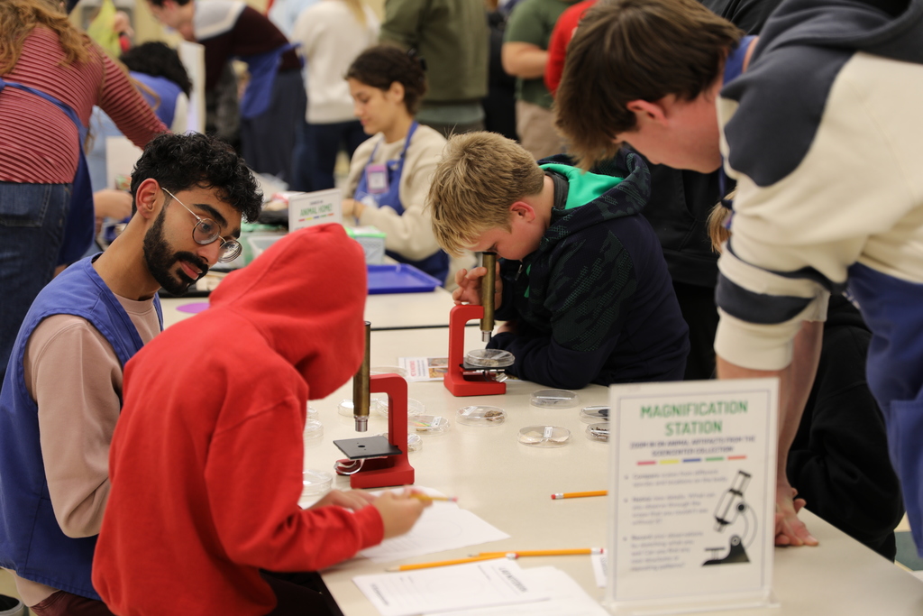 two students looking through microscopes