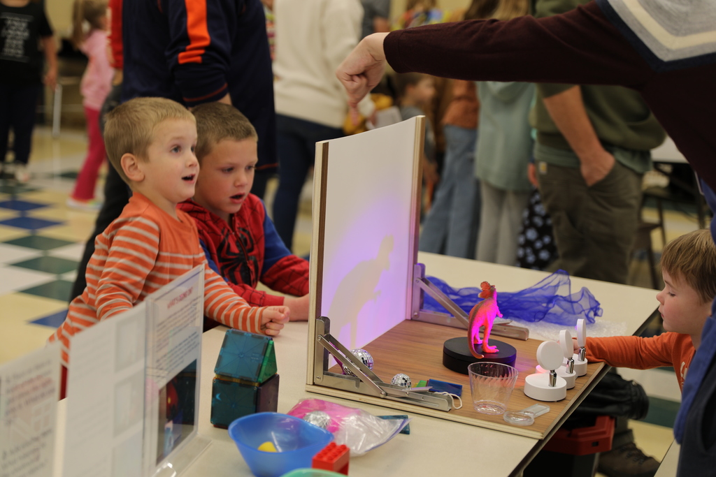 Two students being shown a demo with lights