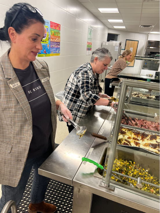 people serving themselves at harvest dinner