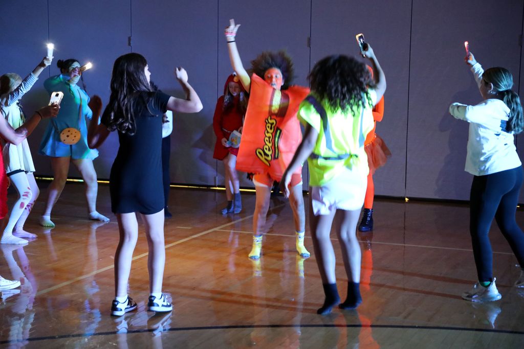 students jumping up as they dance