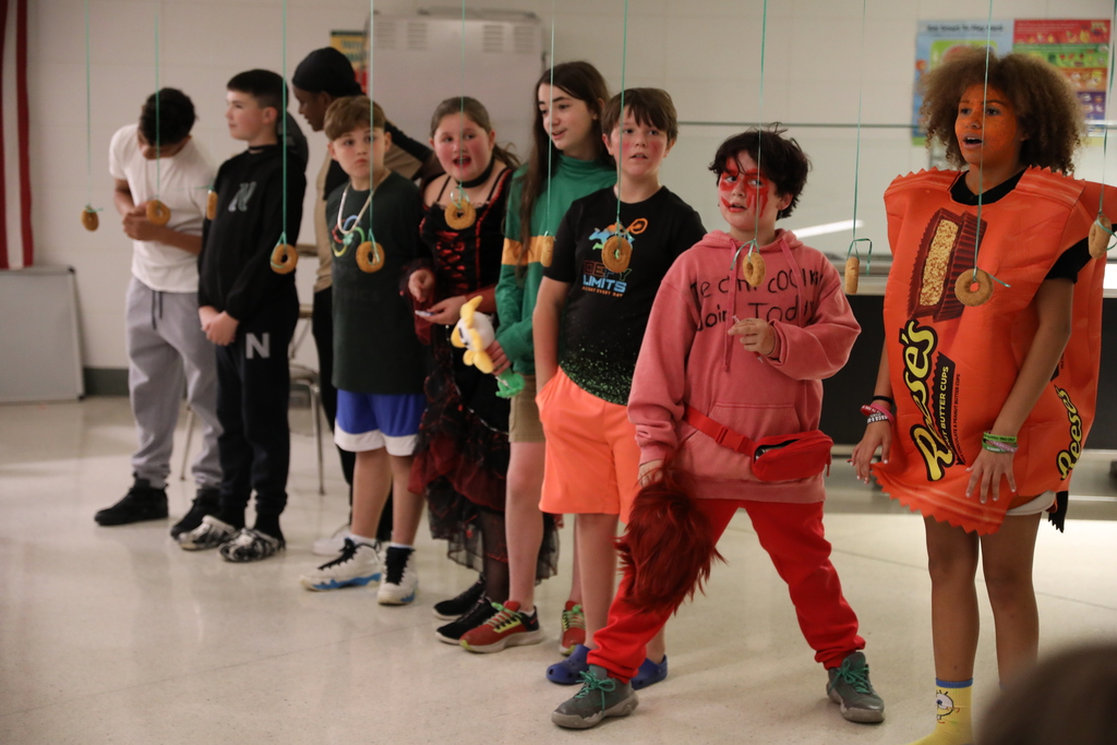 a large group of students waiting to start a donut eating contest