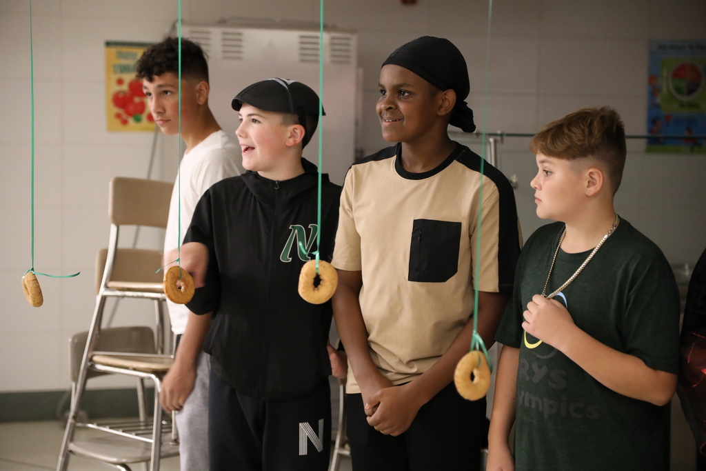 four students waiting to start the donut eating contest