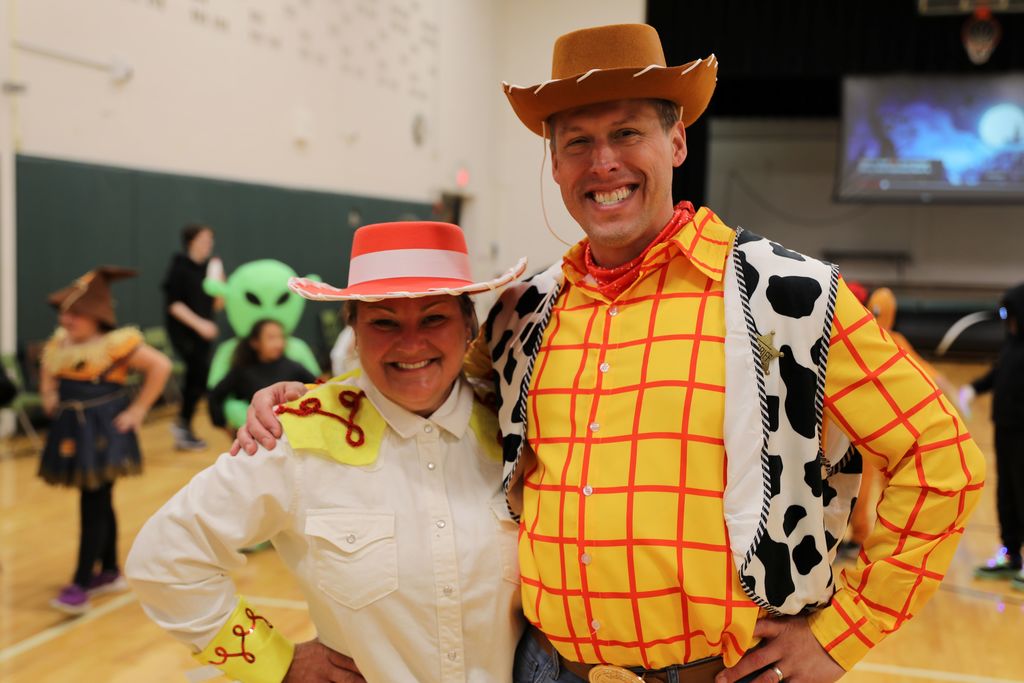 Two adults smiling as they pose for a photo