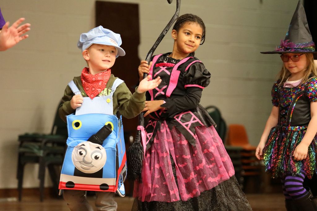 3 students, one dressed as Thomas the Train and the other two look like witches