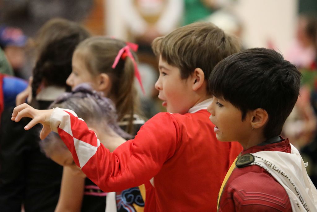 A student making a gesture with his hand as if he was the character he is dressed as