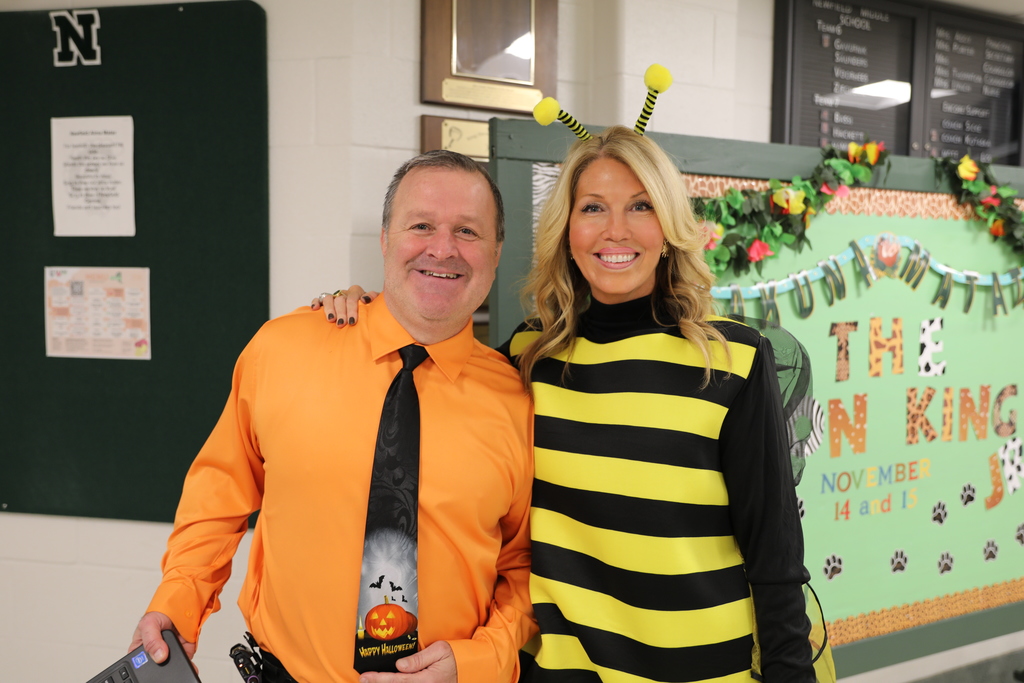 Two adults smile as they pose for a picture
