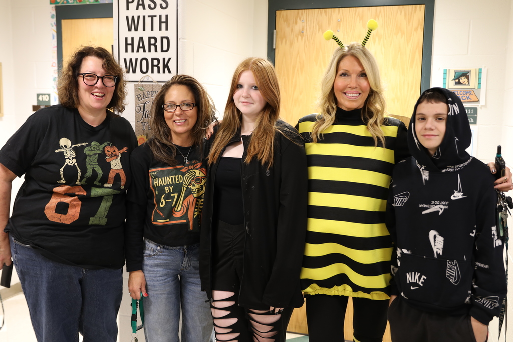 A class photo for Halloween, the entire class standing in the hallways posing for a picture