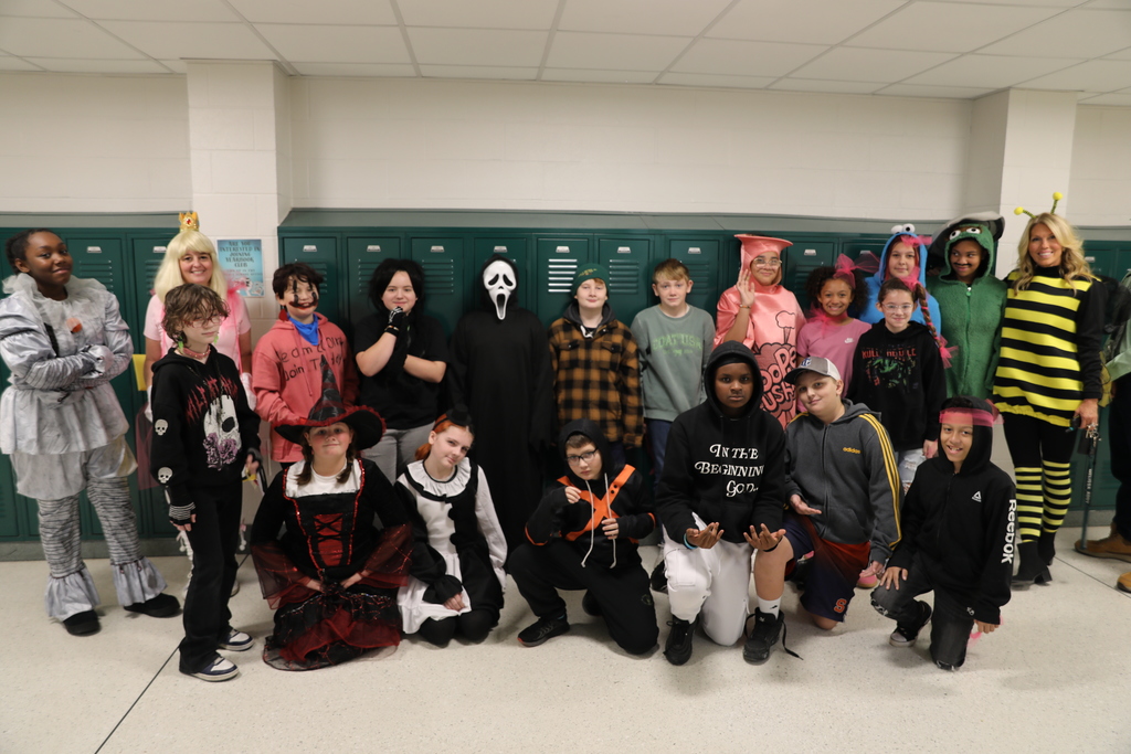 A class photo for Halloween, the entire class standing in the hallways posing for a picture