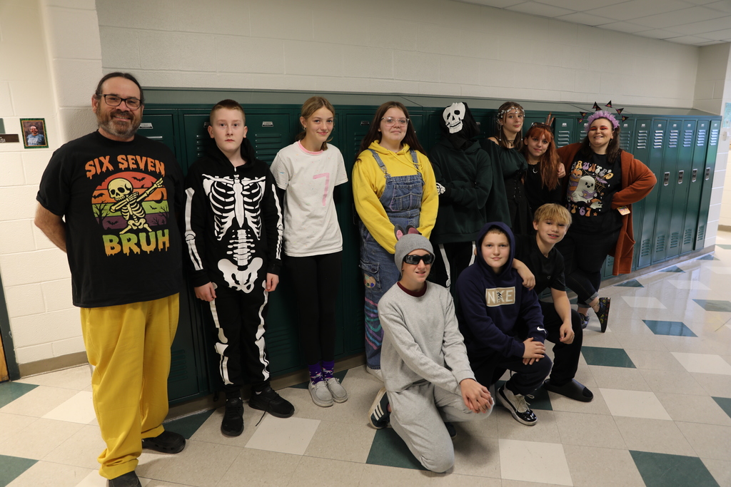 A class photo for Halloween, the entire class standing in the hallways posing for a picture