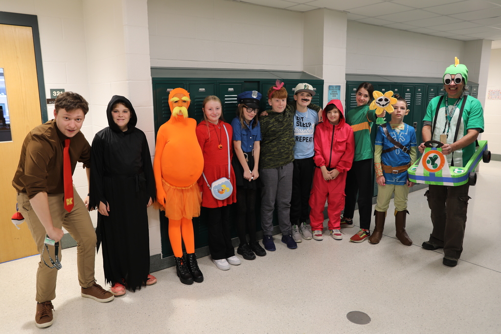 A class photo for Halloween, the entire class standing in the hallways posing for a picture