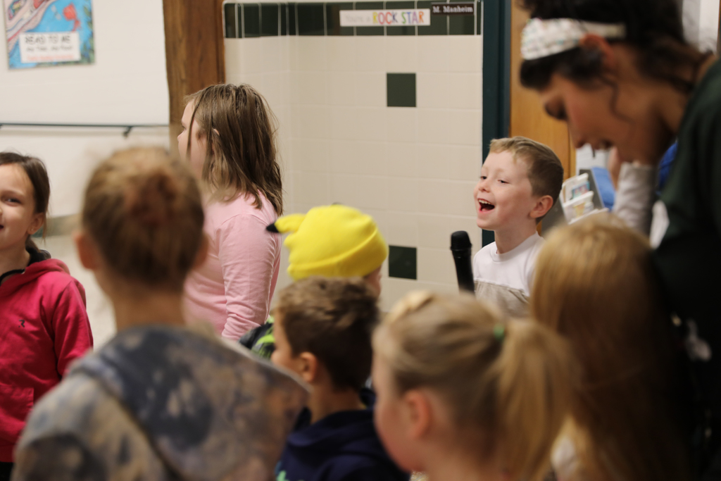 A student smiling as they sing