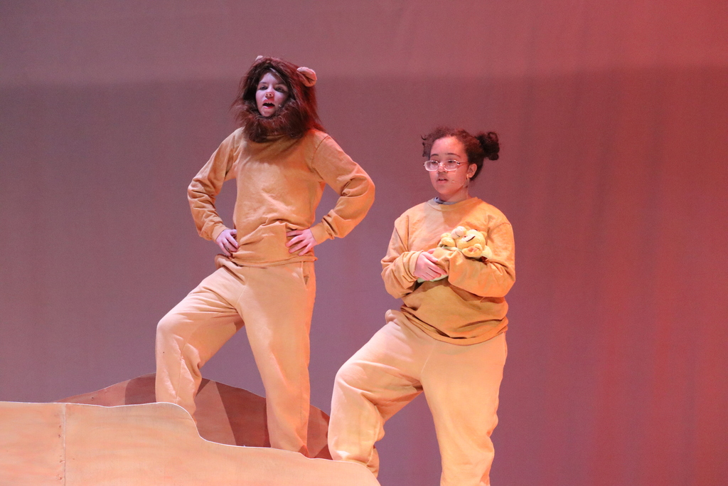 two students standing acting out a scene