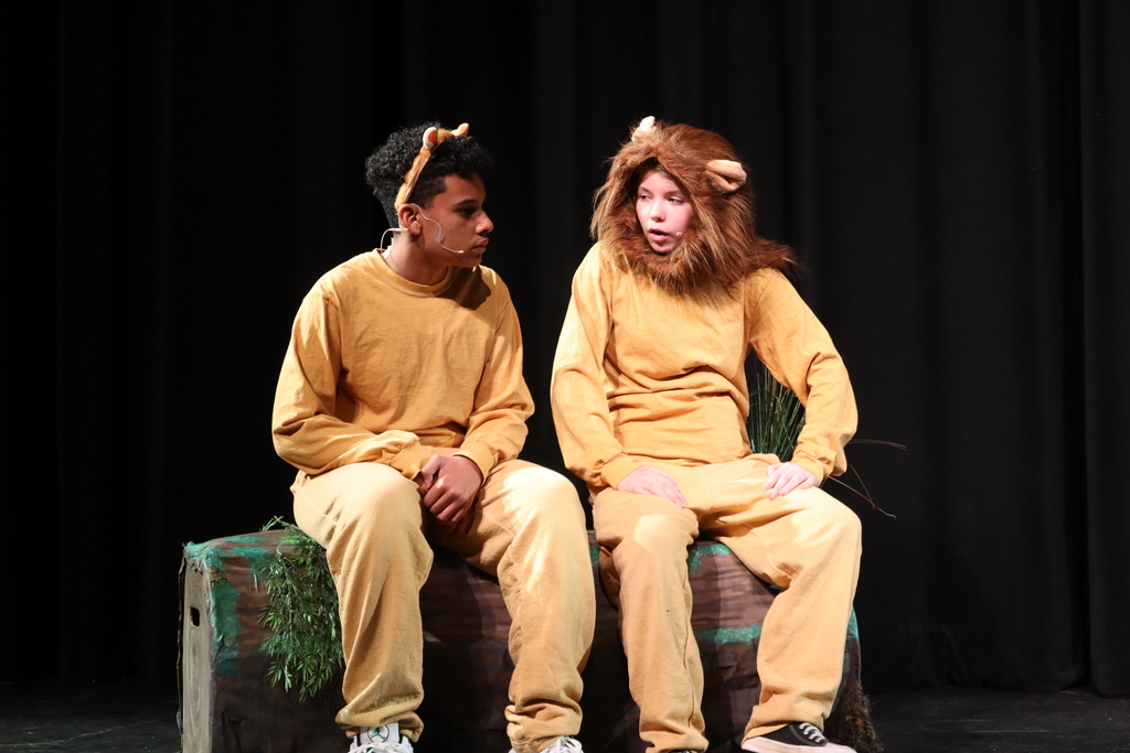 two students sitting acting out a scene
