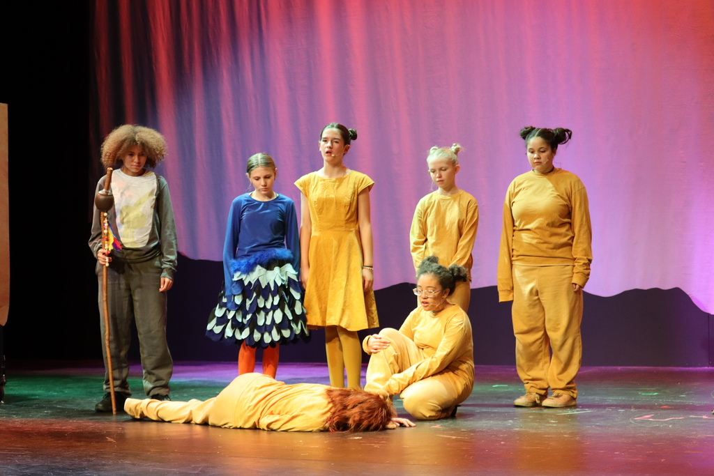 a group of students acting out a scene