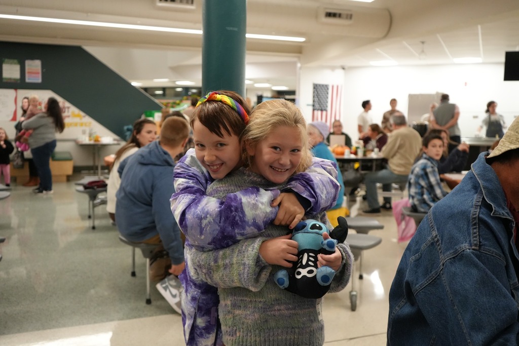 Students hugging at 2nd annual harvest dinner