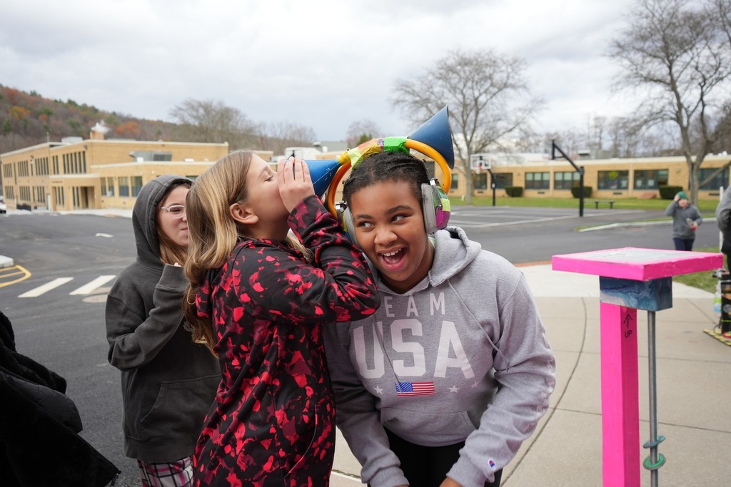 students using the equipment provided by the Physics Bus - whispering into the headphones