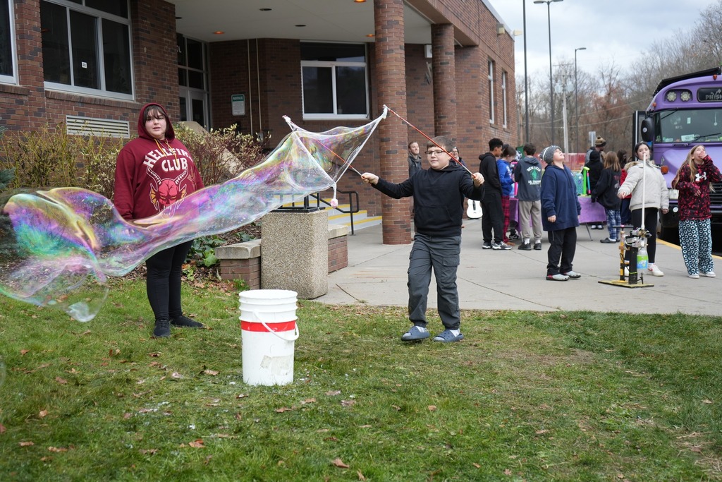 student using bubble station to make huge bubbles