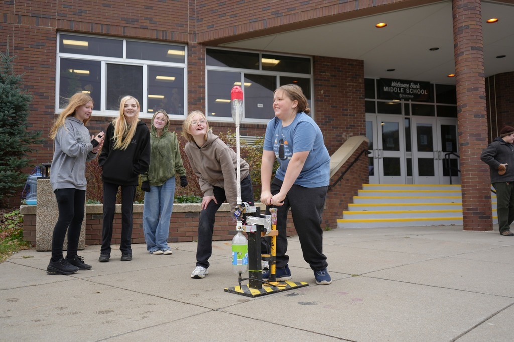 student using bottle launcher into air