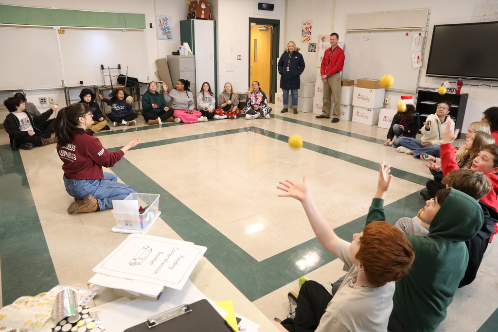 a large group of students practicing juggling 
