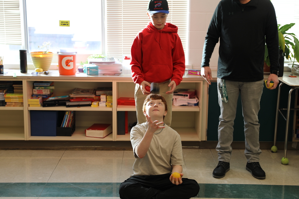 two students practice juggling 