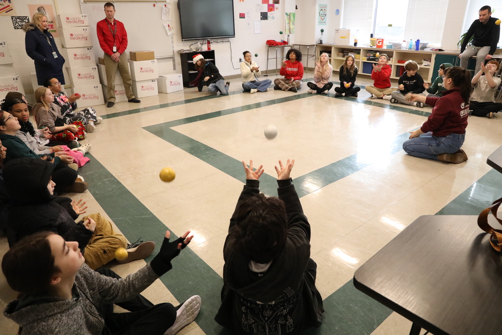 a large group of students practicing juggling 