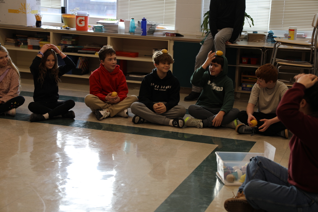 some students balancing balls on their heads