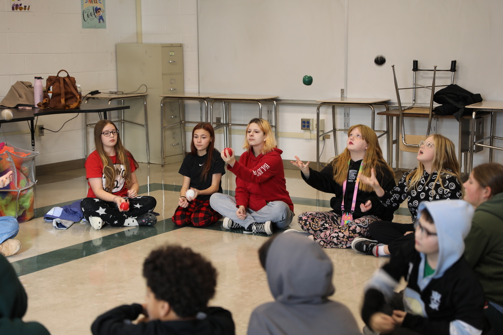 a large group of students practicing juggling 