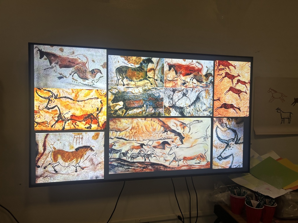 A board showing a collage of images from real cave art from Lascaux, France