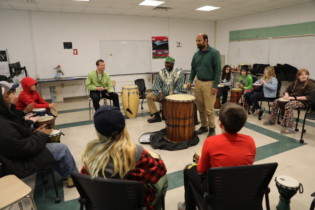 A teacher trying to play the big drum