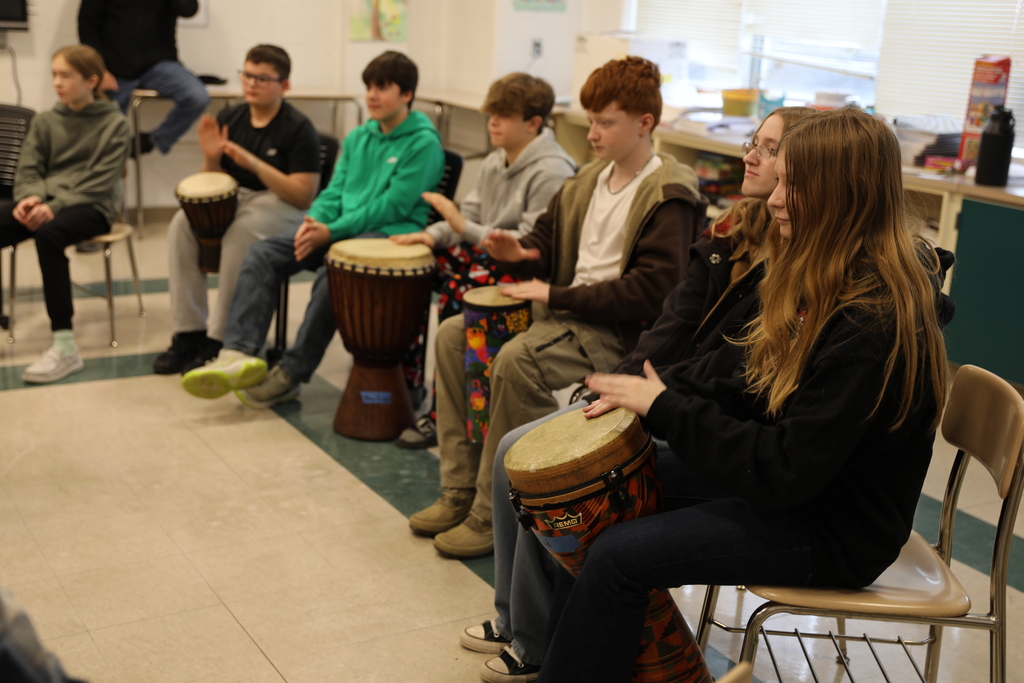 A line of students playing the drums