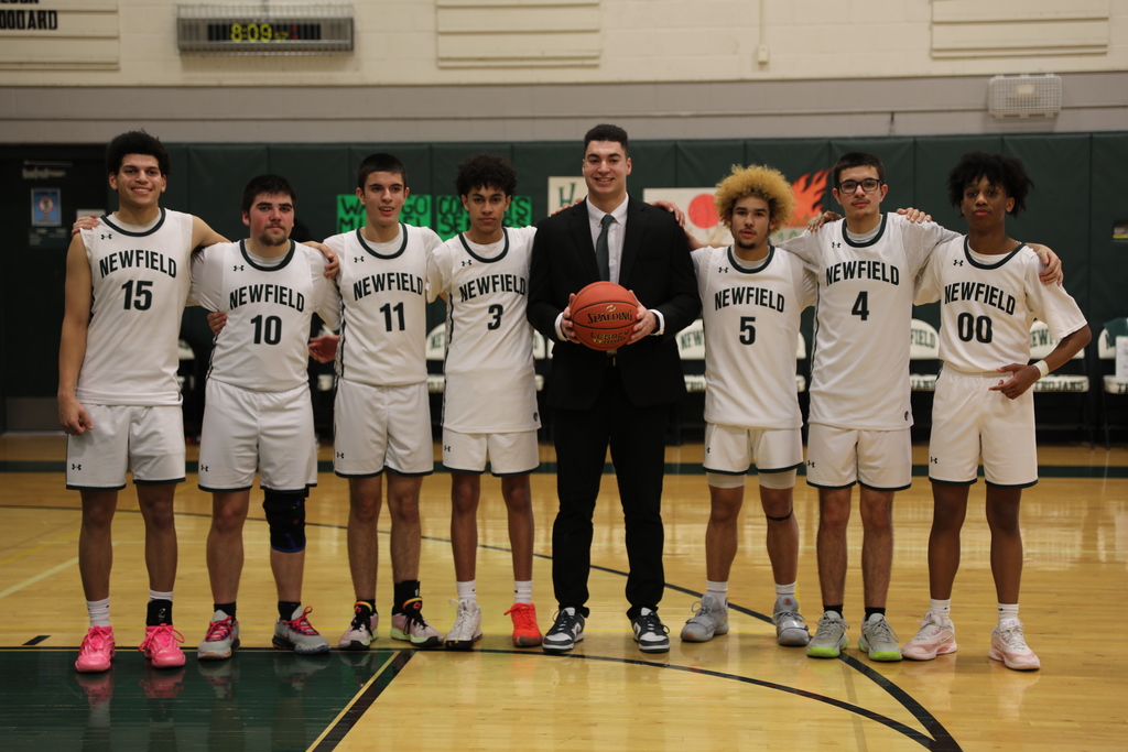 the basketball team posing for a team photo