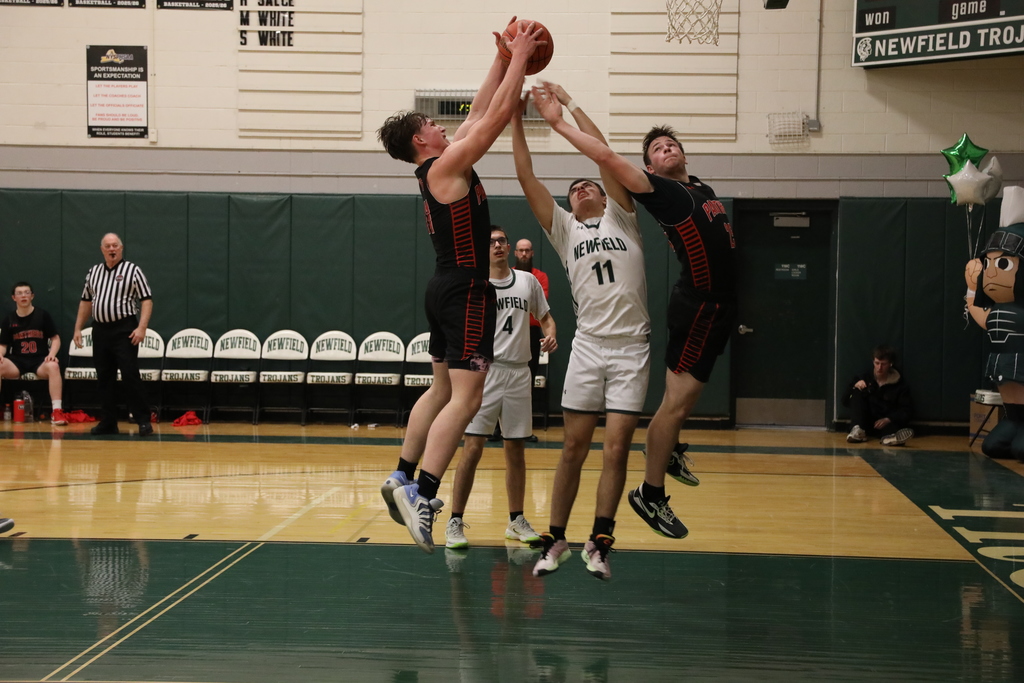 some students leaping to catch the ball rebounding 