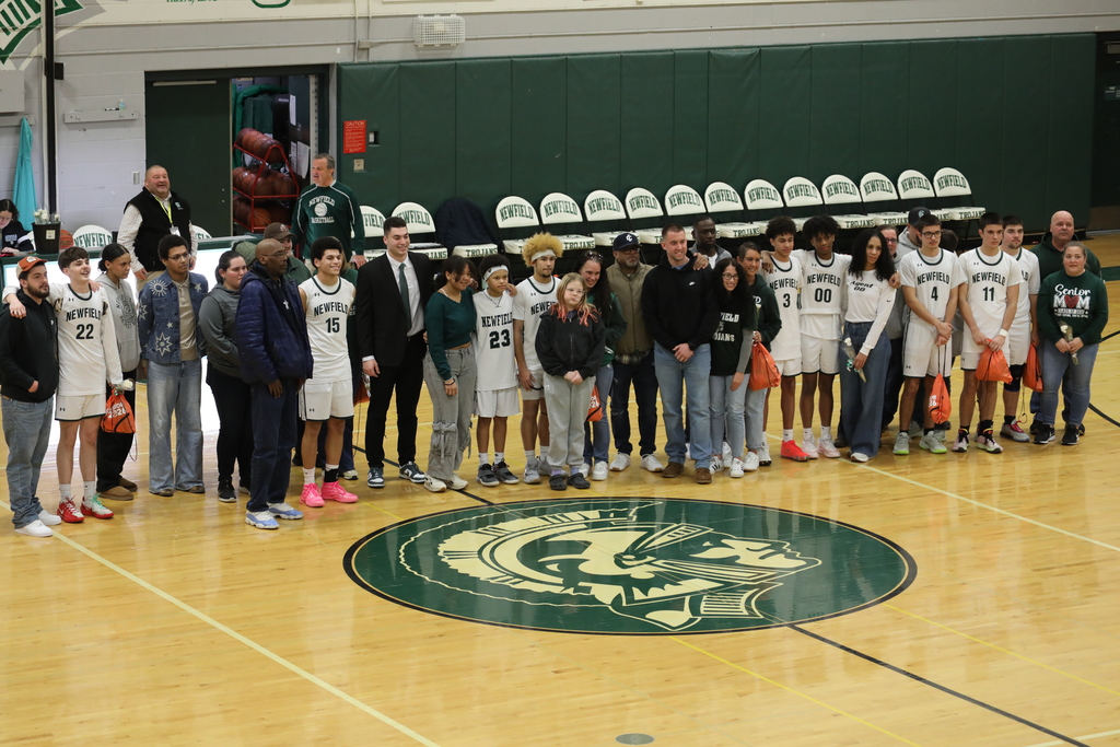 all the seniors from the team standing with their families in a big group photo