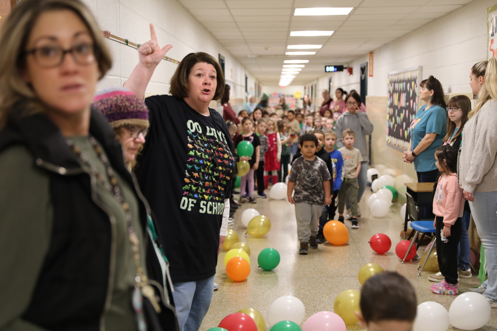 a teacher explaining to the kids how the balloon pop will go