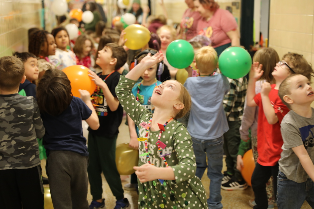 the hall filled with students playing with balloons