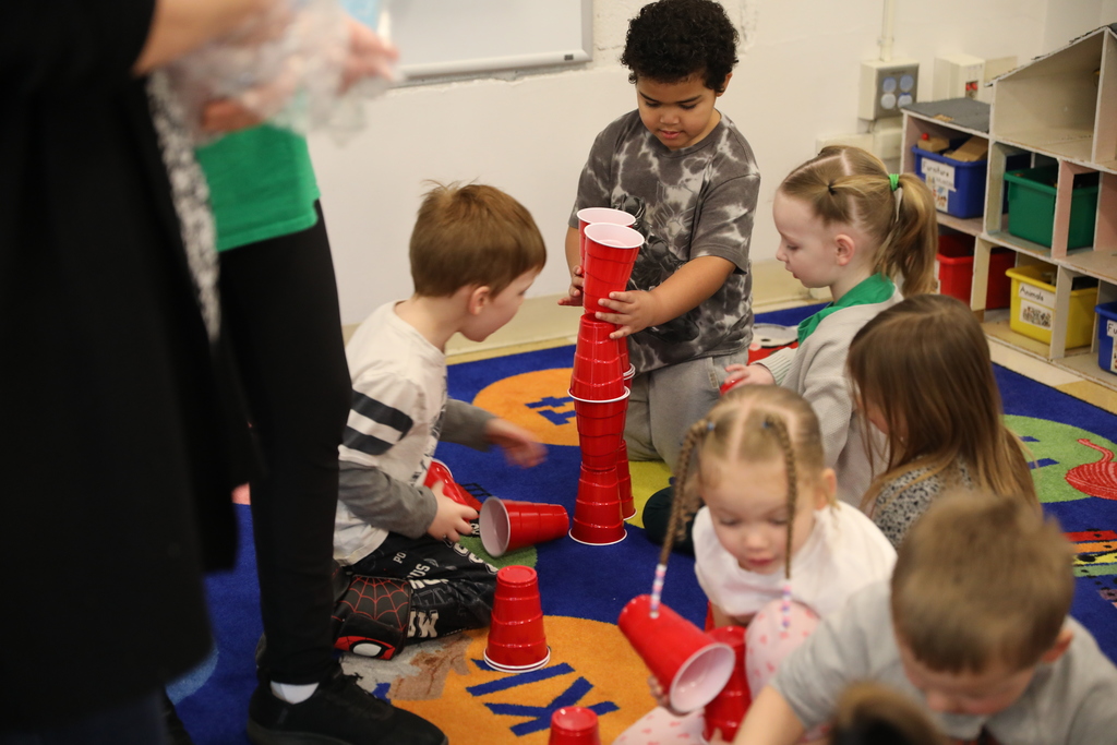 pre-k students stacking reds cups