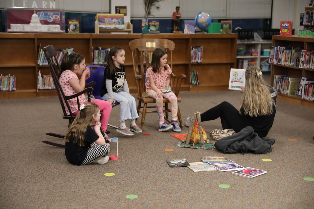 some students being read to in the library
