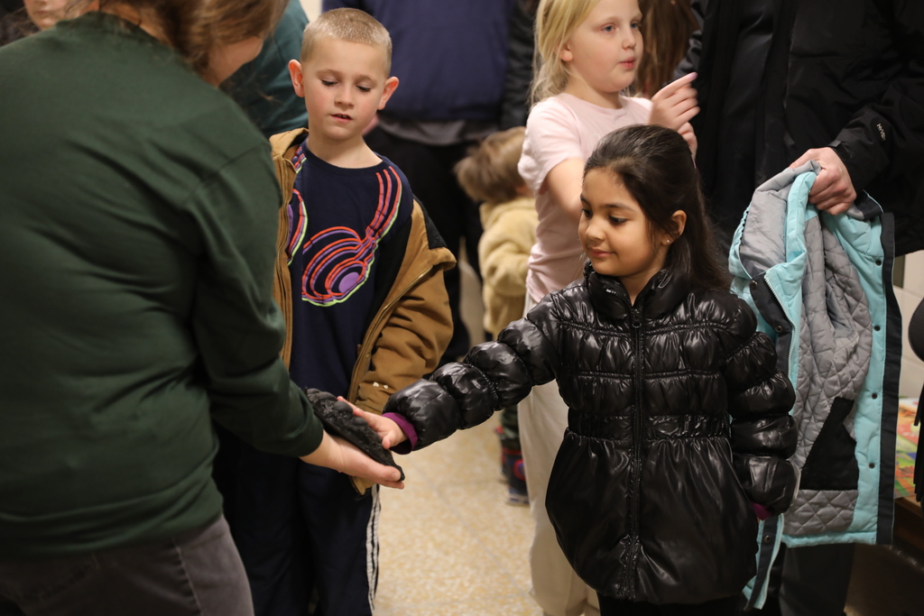 a student touching an animal paw