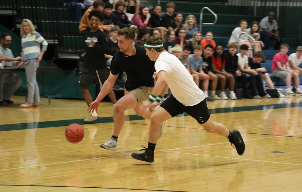 two staff running down the court with the ball