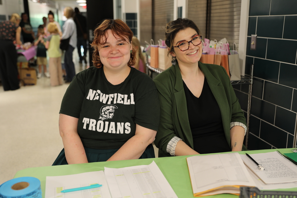 two staff members smiling for the camera