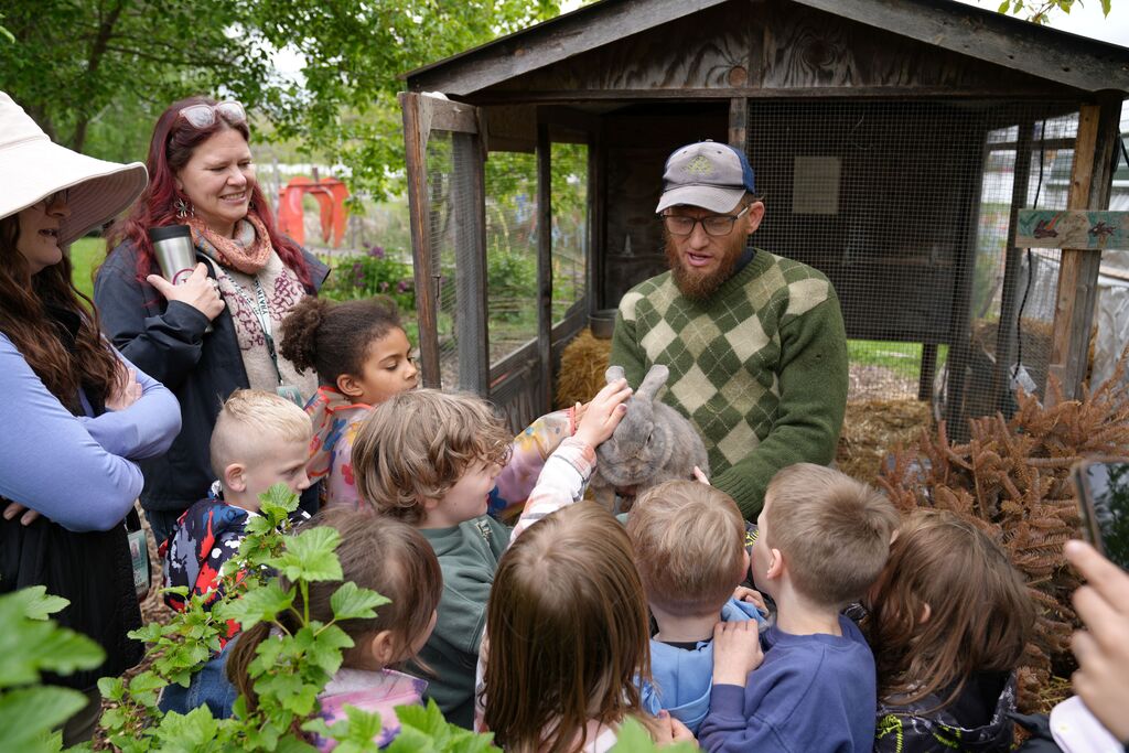 a staff member shows the kids a bunny they can pet