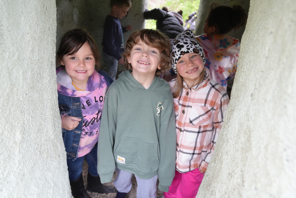 three students smiling for the camera