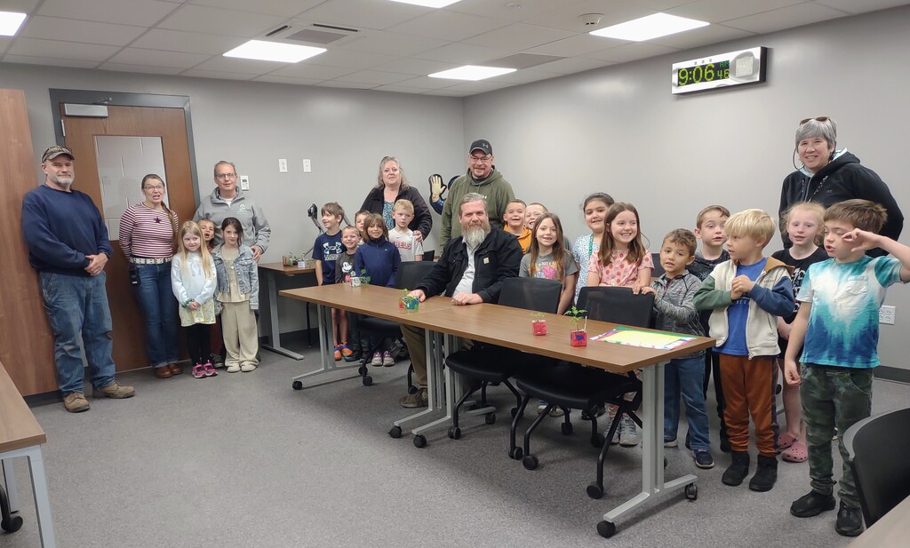a wide picture of students and staff all posing for the camera